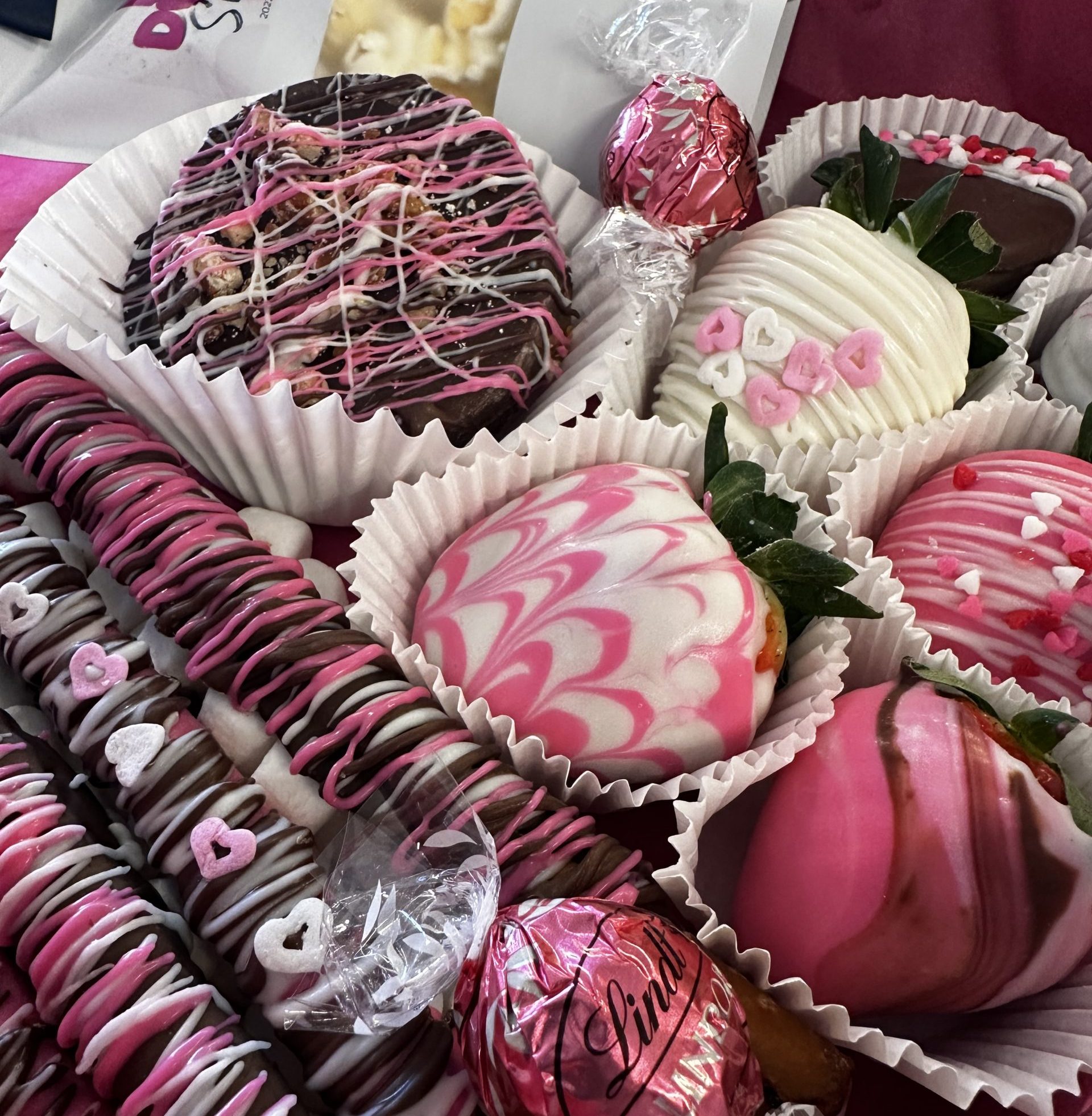Chocolate-covered strawberries, cookies, pretzels and candies nestled inside cupcake liners and displayed in-store. Items are either bagged or covered in multi-colored chocolate.